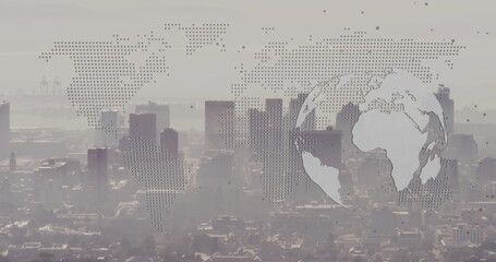 Showing skyscrapers rising above harbor cranes from roof with dot matrix world map, circular globe