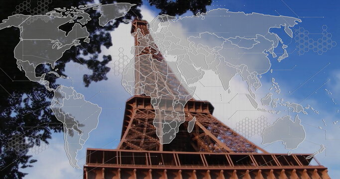 Towering Eiffel Tower climbing toward sky at Paris base, with world map overlay and green branches