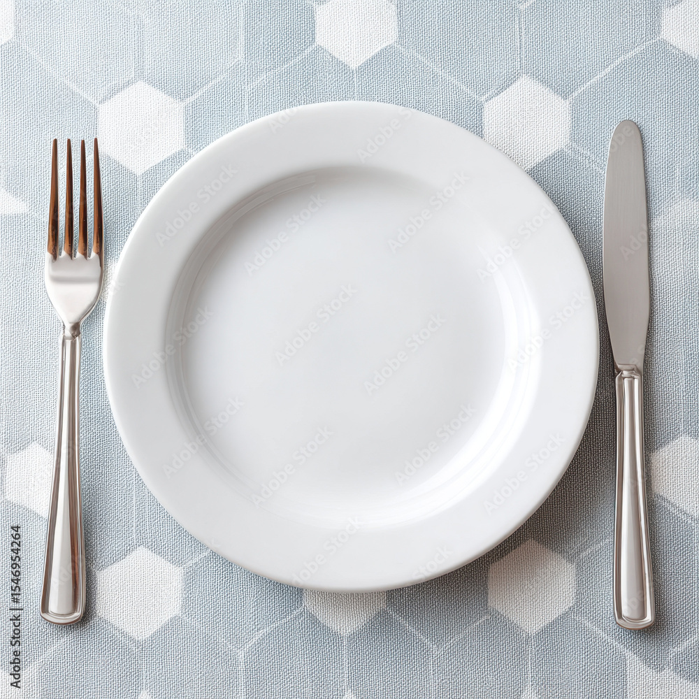 Poster Clean white plate with fork and knife on blue hexagonal patterned tablecloth ready for meal with neat and simple setting