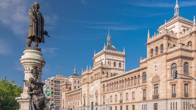 Timelapse of the Cavalry Academy in Plaza de Zorrilla, Valladolid, Spain. Historic military building with intricate architecture, surrounded by a busy urban scene under a blue sky with passing clouds.