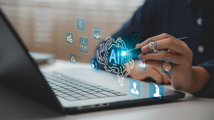 Close-up of hand using stylus with AI interface on laptop screen. Concept of artificial intelligence ecosystem, machine learning, automation, data analytics, and smart digital transformation.