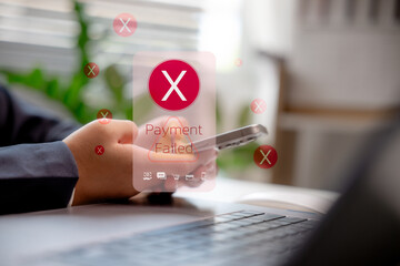 Close-up of person holding smartphone with Payment Failed alert on screen. Concept of digital...