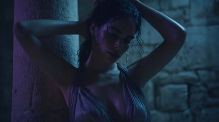 Sensual model posing near stone wall at night