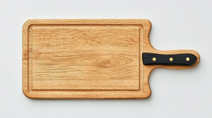Fototapeta premium Light brown wooden cutting board with a black handle.