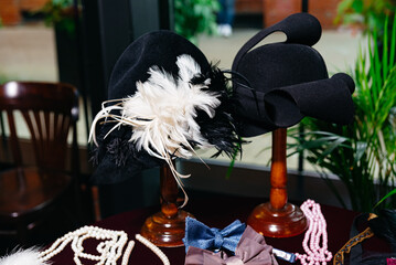 Vintage black hats with feathers and accessories.