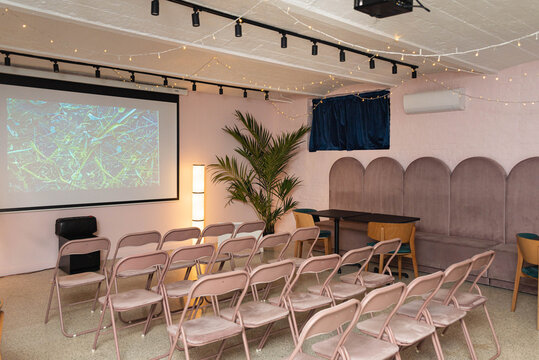 Cozy conference room setup with projector and chairs.