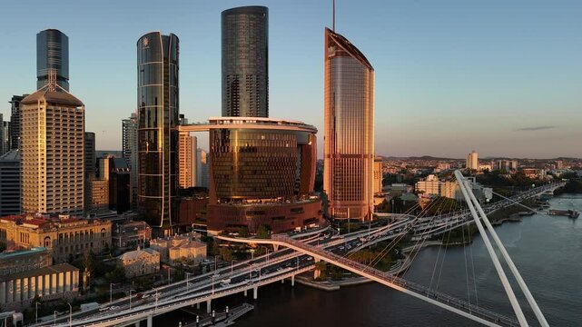 Brisbane CBD, Queensland, Australia: 4K Aerial Sunset Image Featuring City Skyline, Skyscrapers, the Star Brisbane Casino, Brisbane River, Bridges, City Highway and Traffic in Warm Evening Light