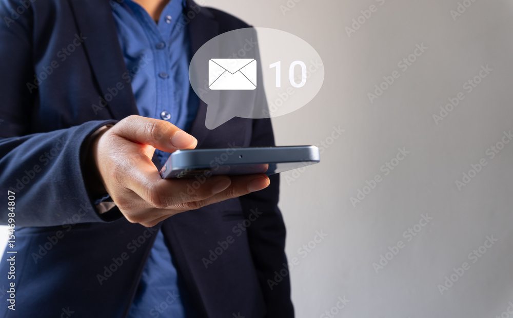 Poster close-up of a business person's hand holding a smartphone and showing an envelope icon with a number