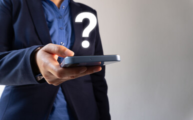 Businessman holding a smartphone with a question mark icon on the screen
