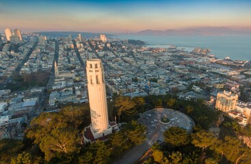 Aerial view of Coit Tower in San Francisco, California, USA, at sunrise. The tower is a monument to...