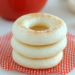 Stack of fresh, homemade, white donuts with cinnamon sprinkles close up shot photo