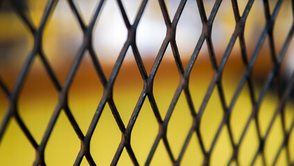 Abstract iron lattice detail showcases depth with shallow focus during bright day light.