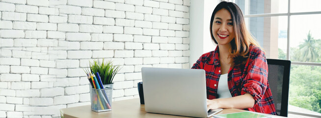 Banner Woman typing laptop computer online meeting at home office work from home. Asian...