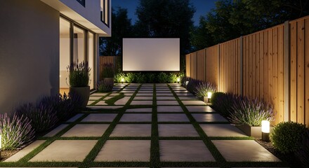 Outdoor space at night. Modern backyard with concrete pavers and grass, a lit screen, and a wooden fence. Lavenders and bushes line the walkway.