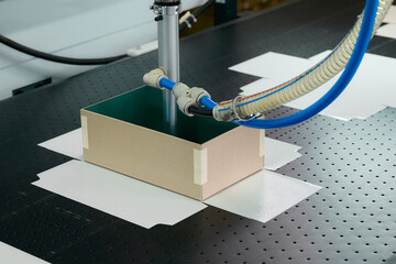 Innovative robotics in action at a box manufacturing facility utilizing advanced gluing techniques...
