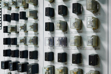 Wall of vintage electrical components displayed in an industrial setting for educational purposes