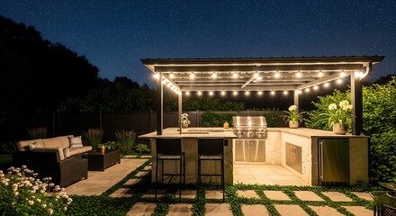 Outdoor kitchen at dusk. Features string lights, grill, counter, stools, & seating area. Stars visible in the night sky add to the ambiance.
