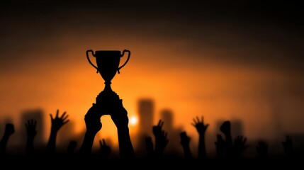 Silhouetted hands reaching for a trophy against a vibrant sunset skyline, celebrating achievement