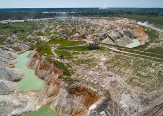 Walking dragline and excavator on trench bank at chalkquarry