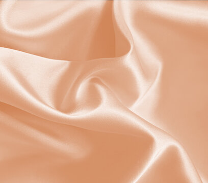 Luxury elegant silk satin sleek fabric background. Macro studio shot.  Tea rose lip pink light lady melon coral beige deep peach almond desert sand nude tan cream linen champagne cotton candy. 