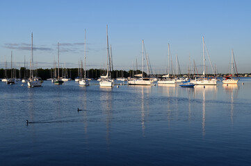 Sailboats at anchor off Coconut grove in Miami, Florida on clear sunny morning.