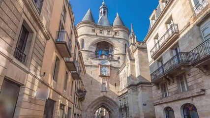 Porte Saint Eloi timelapse hyperlapse, also called Grosse Cloche, is a medieval gothic gate in Bordeaux, France. A symbol of the city's history with a big bell and clock. Blue sky enhances its beauty