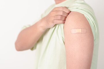Adult Man with bandage after received vaccine. Vaccination and Immunization for Influenza, HPV,...