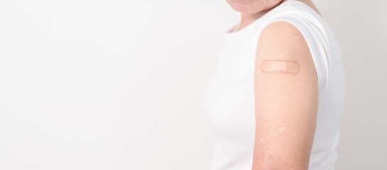 Elderly Woman with bandage after received vaccine. Vaccination and Immunization for Influenza,...
