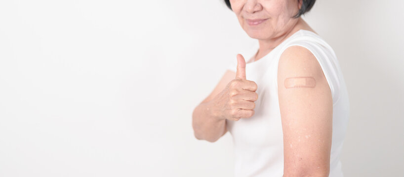 Elderly Woman with bandage after received vaccine. Vaccination and Immunization for Influenza, Herpes Zoster, Tetanus, Covid 19 booster, Dengue, Encephalitis, Rabies, Pneumococcal, IPD, RSV Vaccines - Powered by Adobe