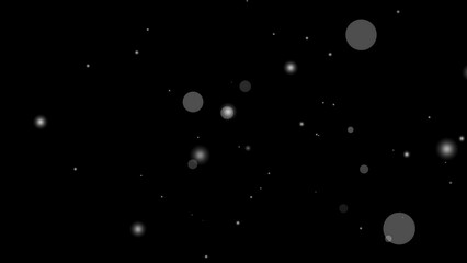 White particle overlay creates a hazy effect on a black background with white blurry circles