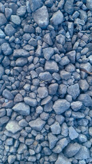 A collection of small gravel stones commonly used for construction, landscaping, or as a base layer in roads and pathways. These pebbles vary in size and color, offering a natural and durable surface.