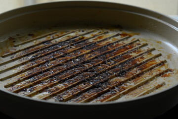 dirty white circle pan after cooking in home