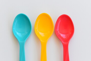 colorful spoon isolated on white background, plastic cutlery for picnic