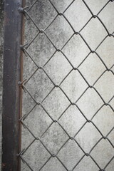 old wire mesh on dirty wall, construction industry