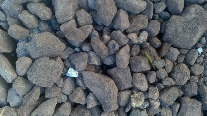 A collection of small gravel stones commonly used for construction, landscaping, or as a base layer in roads and pathways. These pebbles vary in size and color, offering a natural and durable surface.