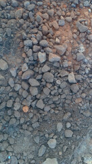 A collection of small gravel stones commonly used for construction, landscaping, or as a base layer in roads and pathways. These pebbles vary in size and color, offering a natural and durable surface.