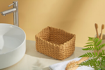 Wicker basket and soft towels on bathroom counter with sunlight. Natural and open composition ideal...