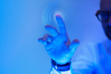 Man touching the futuristic blue screen