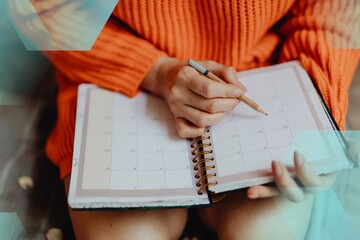 Woman writing on her daily planner