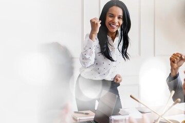 Businesswoman motivating her team members in a meeting