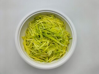 Sour raw mangoes are chopped and sliced into small pieces and arranged in a bowl to make Mango...