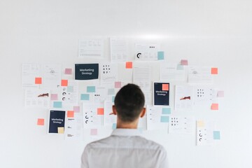 A casual business man looking at a marketing plan