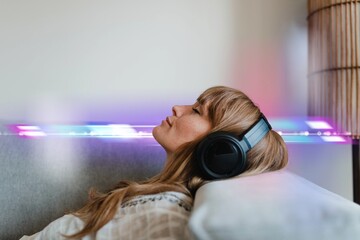 Woman listening to music at home during coronavirus pandemic