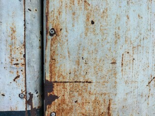 A gate made from steel sheets fastened with rivets. After being used for a long time, it began to deteriorate and decay from rust.