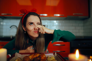 Woman Pinching her Nose After Failing Dinner Making. Housewife overcooking the meal making a mistake