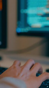 Vertical Screen : Closeup young adult Asia female freelance typing write prompt AI bot IT program nomad, video game, terminal with coding language, big data center on desktop computer in night office.