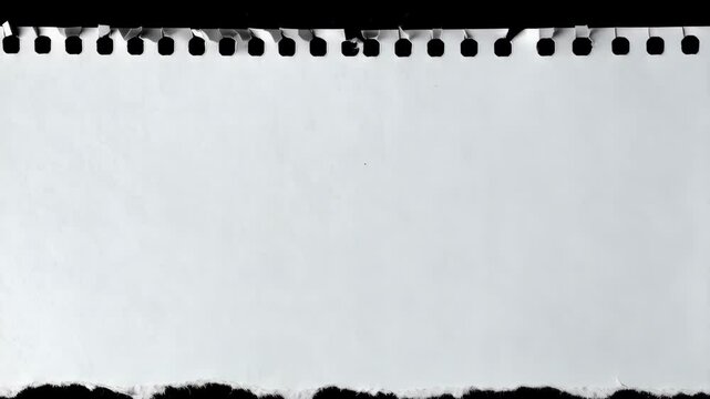 Close-up of a perforated white paper sheet with torn bottom edge against black background for presentations or creative projects.