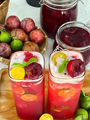 Refreshing Vietnamese Plum Tea with Kumquat and Coconut Jelly on Wooden Tray