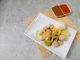 Siomay Bandung (Shumay) or steamed dumplings with boiled egg, tofu, potato, bitter melon and...