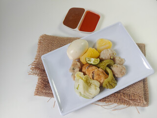Siomay Bandung (Shumay) or steamed dumplings with boiled egg, tofu, potato, bitter melon and...